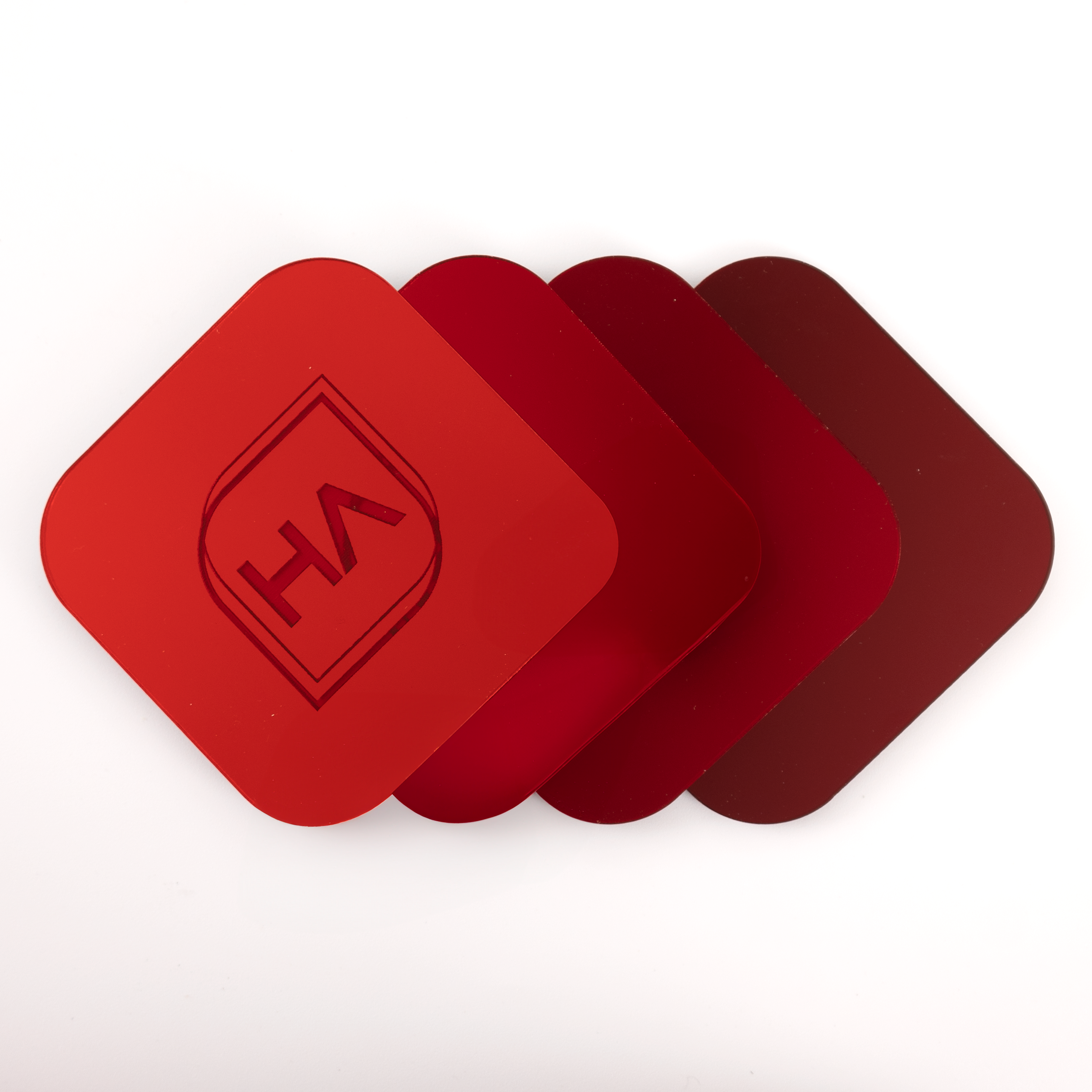 Houston Acrylic's red mirrors in a row showing the color grade across the 4 shades.